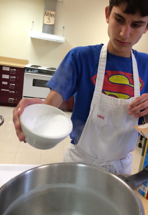 Adding salt to the pasta water.