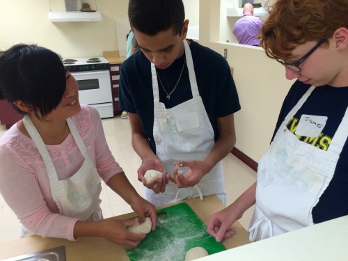 After the dough had risen slowly overnight to develop flavor and texture, the students began shaping portions of it into pizza shells. 