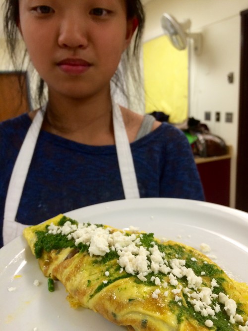 The finished frittata, garnished with fresh crumbled feta.