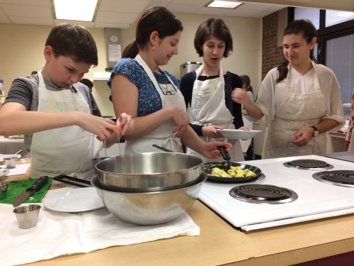 Team of four cooking together