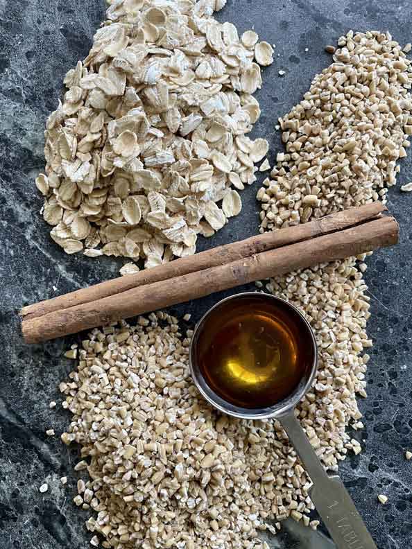 oats, cinnamon stick and spoonful of honey on table