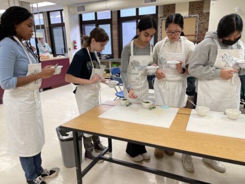 Students garnishing DIY soups