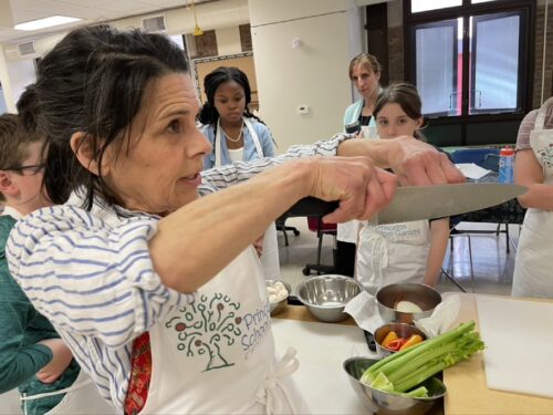 Teacher demonstrating how to hold a knife